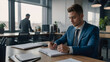 © New generate - young man in suit writing business papers at desk in modern coworking office. copy space