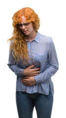 Wall Mural - Young redhead bussines woman with hand on stomach because indigestion, painful illness feeling unwell. Ache concept.