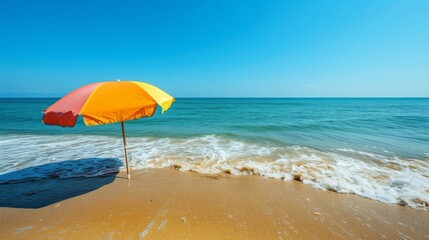 Poster - A serene beach scene featuring gentle waves lapping against the shore and a colorful beach umbrella providing shade