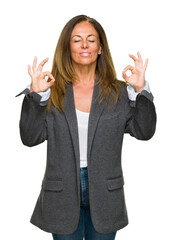 Sticker - Middle age adult woman wearing oversize boyfriend jacket over isolated background relax and smiling with eyes closed doing meditation gesture with fingers. Yoga concept.