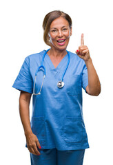 Wall Mural - Middle age senior nurse doctor woman over isolated background pointing finger up with successful idea. Exited and happy. Number one.