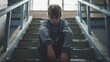 © Bijac - lonely school boy sitting on stairs victim of bullying childhood mental health concept