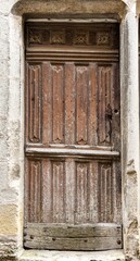 Wall Mural - Old wooden door in a stoned ancient frame