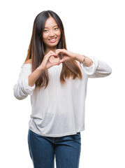 Poster - Young asian woman over isolated background smiling in love showing heart symbol and shape with hands. Romantic concept.