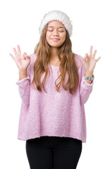 Sticker - Young beautiful brunette woman wearing sweater and winter hat over isolated background relax and smiling with eyes closed doing meditation gesture with fingers. Yoga concept.