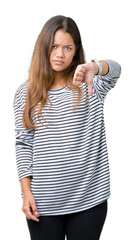 Sticker - Young beautiful brunette woman wearing stripes sweater over isolated background looking unhappy and angry showing rejection and negative with thumbs down gesture. Bad expression.