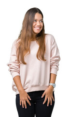 Wall Mural - Young beautiful brunette woman wearing pink sweatshirt over isolated background looking away to side with smile on face, natural expression. Laughing confident.