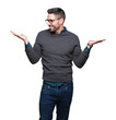 © Krakenimages.com - Young handsome man wearing glasses over isolated background Smiling showing both hands open palms, presenting and advertising comparison and balance