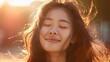 © Working Moments - Smiling Asian woman with long hair and eyes closed, studio portrait