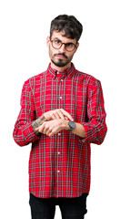 Poster - Young handsome man wearing glasses over isolated background In hurry pointing to watch time, impatience, upset and angry for deadline delay