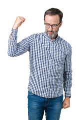 Canvas Print - Handsome middle age elegant senior man wearing glasses over isolated background Strong person showing arm muscle, confident and proud of power