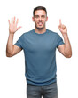 © Krakenimages.com - Handsome young casual man showing and pointing up with fingers number six while smiling confident and happy.