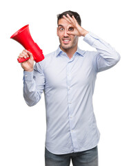 Poster - Handsome young man holding microphone with happy face smiling doing ok sign with hand on eye looking through fingers