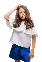 Wall Mural - Brunette hispanic girl confuse and wonder about question. Uncertain with doubt, thinking with hand on head. Pensive concept.