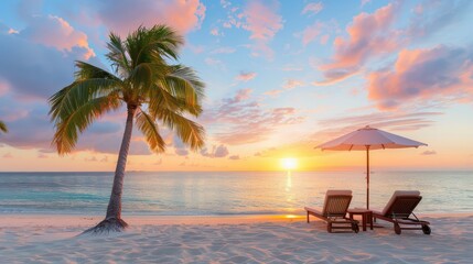 Leinwandbilder - A beach scene with a palm tree and two lounge chairs. The sun is setting, creating a warm and relaxing atmosphere