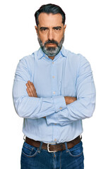 Wall Mural - Middle aged man with beard wearing business shirt skeptic and nervous, disapproving expression on face with crossed arms. negative person.