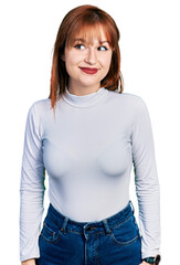 Poster - Redhead young woman wearing casual turtleneck sweater smiling looking to the side and staring away thinking.