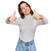 © Krakenimages.com - Young caucasian girl wearing casual clothes approving doing positive gesture with hand, thumbs up smiling and happy for success. winner gesture.