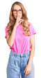 © Krakenimages.com - Young beautiful caucasian woman with blond hair wearing casual clothes and glasses asking to be quiet with finger on lips. silence and secret concept.