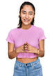 © Krakenimages.com - Hispanic teenager girl with dental braces wearing casual clothes hands together and fingers crossed smiling relaxed and cheerful. success and optimistic