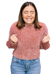 Poster - Young beautiful woman wearing casual clothes excited for success with arms raised and eyes closed celebrating victory smiling. winner concept.