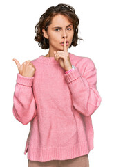 Poster - Young hispanic woman wearing casual clothes asking to be quiet with finger on lips pointing with hand to the side. silence and secret concept.