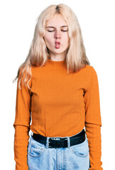 Canvas Print - Young caucasian woman wearing casual clothes making fish face with lips, crazy and comical gesture. funny expression.