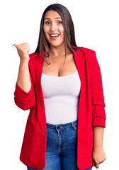 Poster - Young beautiful brunette woman wearing elegant clothes smiling with happy face looking and pointing to the side with thumb up.