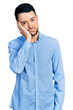 © Krakenimages.com - Hispanic man with beard wearing casual business shirt thinking looking tired and bored with depression problems with crossed arms.