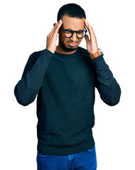 Poster - Young african american man wearing casual clothes and glasses with hand on head for pain in head because stress. suffering migraine.