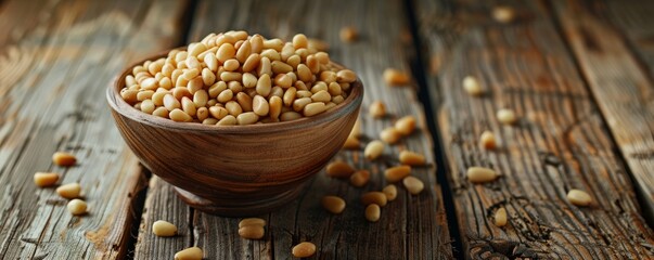 Wall Mural - Wooden bowl filled with pine nuts on rustic wooden table, healthy eating concept