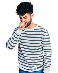 Sticker - Young arab man with beard wearing casual striped sweater feeling unwell and coughing as symptom for cold or bronchitis. health care concept.