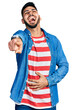 © Krakenimages.com - Young hispanic man with beard wearing casual denim jacket laughing at you, pointing finger to the camera with hand over body, shame expression