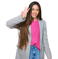 Wall Mural - Young hispanic girl wearing business clothes showing and pointing up with fingers number three while smiling confident and happy.