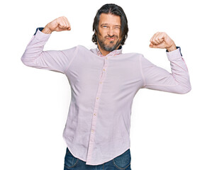 Canvas Print - Middle age handsome man wearing business shirt showing arms muscles smiling proud. fitness concept.