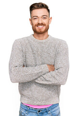 Wall Mural - Young redhead man wearing casual winter sweater happy face smiling with crossed arms looking at the camera. positive person.