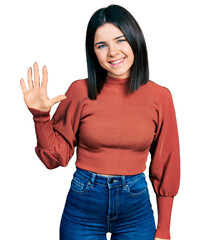 Poster - Young brunette woman with blue eyes wearing elegant sweater showing and pointing up with fingers number five while smiling confident and happy.