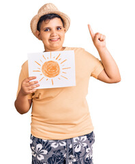 Little boy kid holding sun draw surprised with an idea or question pointing finger with happy face, number one