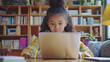 © France - Image of a middle school girl using her parents' laptop for homework in a library with bookshelves in the background, child, girl, laptop, study, homework, desk, library, bookshelf, AI-generated.