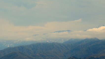 Mountain Landscape Under A Blue Sky. Showcases The Mesmerizing Sight Of Floating Clouds Against The Background Of Mountain.