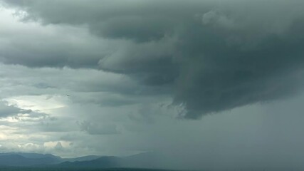 Wall Mural - timelapse of clouds over a mountain with dramatic sky, nature environment dark huge cloud sky black 