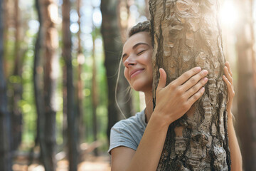 Wall Mural - a woman hugging a tree in a forest