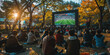 © khonkangrua - People gathered in a park watching a soccer match on a big screen during autumn, creating a lively outdoor viewing experience.