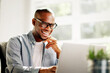 © Andrey Popov - African American businessman working on laptop at office desk