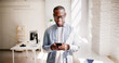 © Andrey Popov - An African-American businessman expertly manages sales through a smartphone app