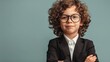 © Wayu - A cute boy in a business suit stands with his arms crossed and looks at the camera. The background has space for text.