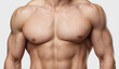 © songsakpandet - Attractive male torso closeup isolated on white background.