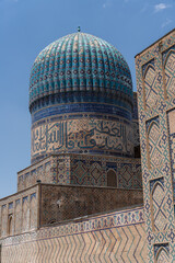 Sticker - A blue dome on top of a building with Arabic writing. The building is old and has a lot of detail