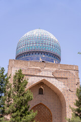 A blue dome on top of a building with a blue roof. The building is old and has a lot of detail on it