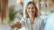 © Photolife   - Caucasian smiling middle aged businesswoman shaking hands with business partner, shaking hands to conclude deal while in office
